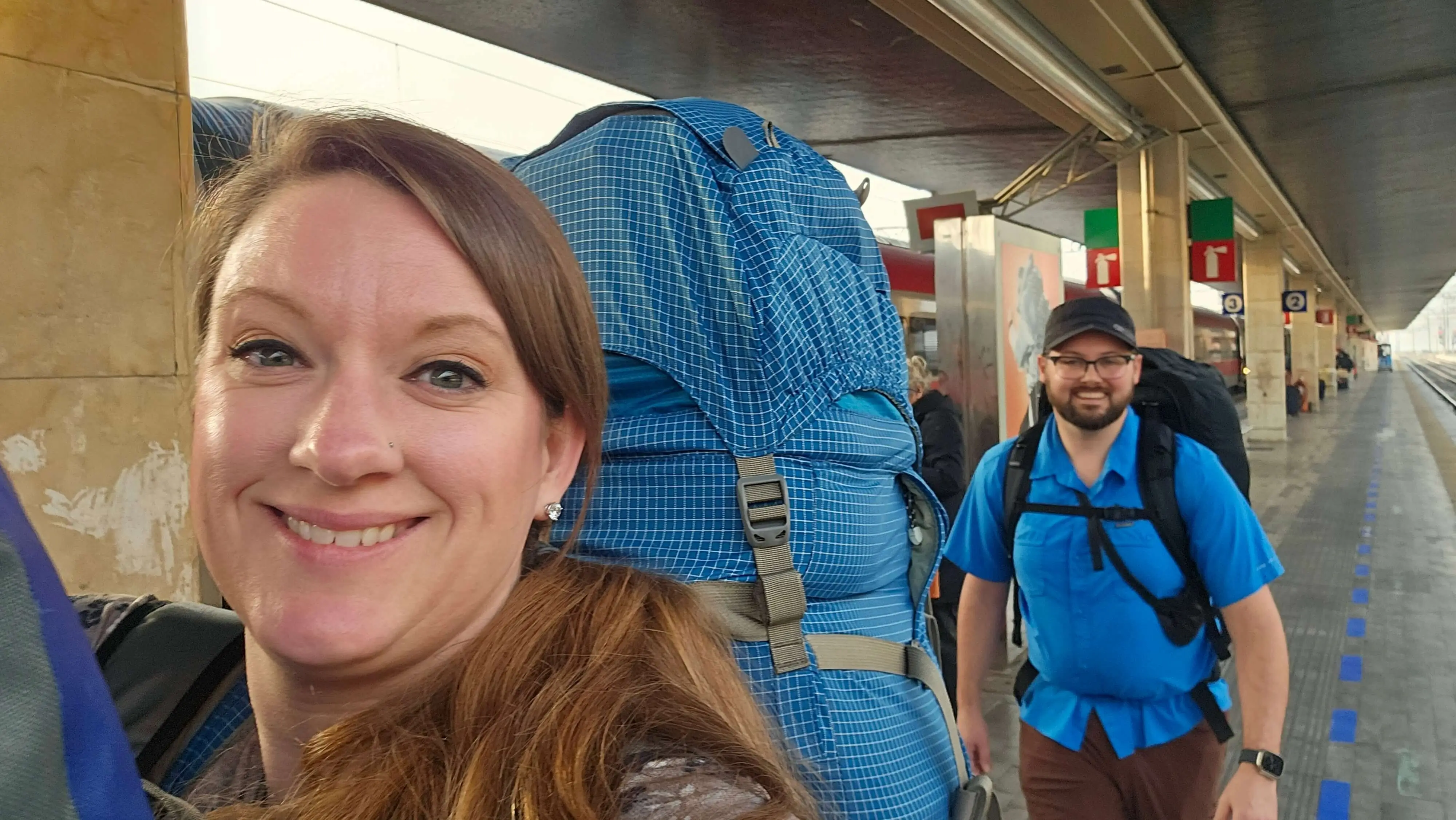 Annica and Paul backpacking at a train station