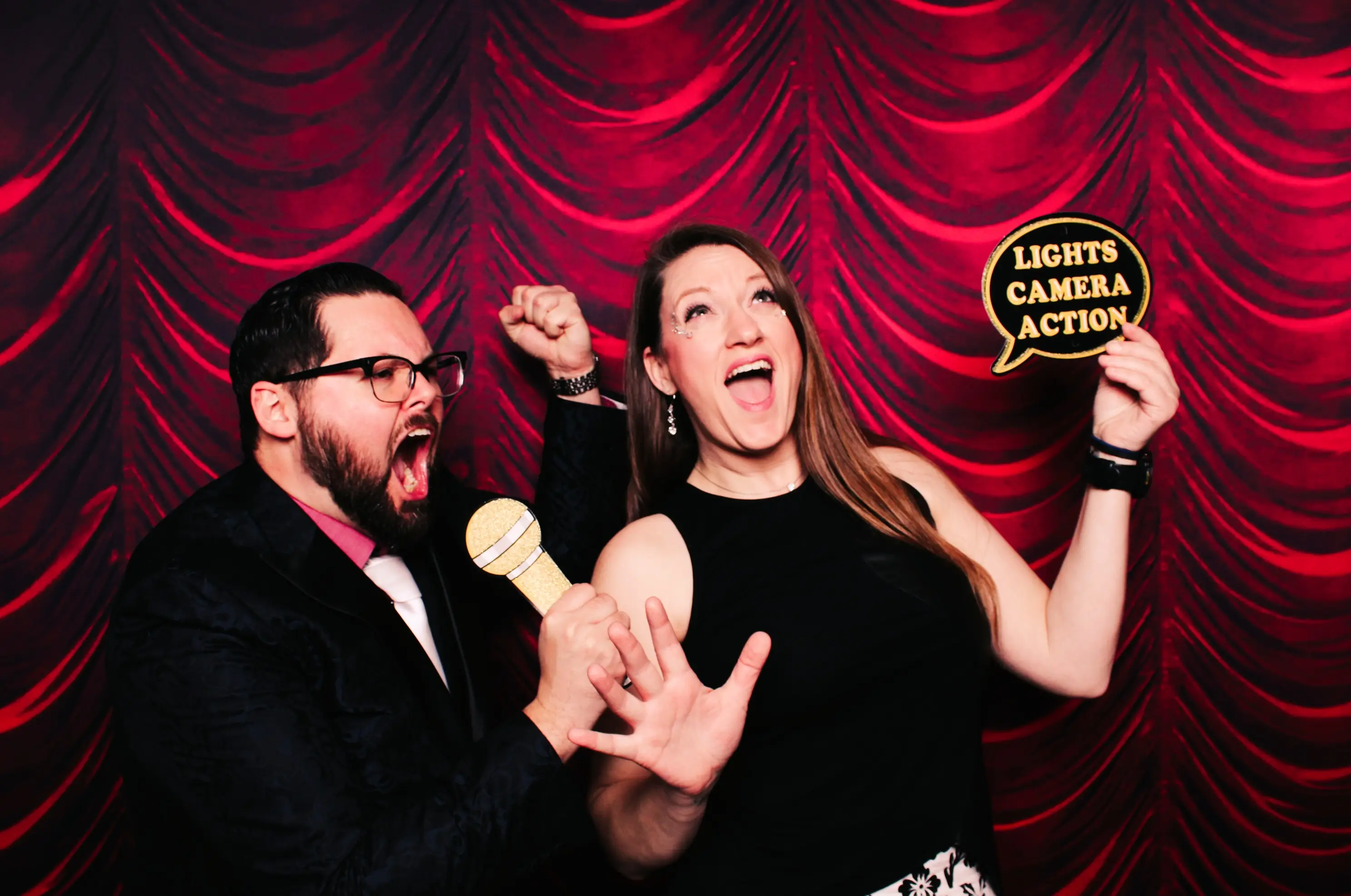 Paul and Annica posing at a photo booth in a movie motif